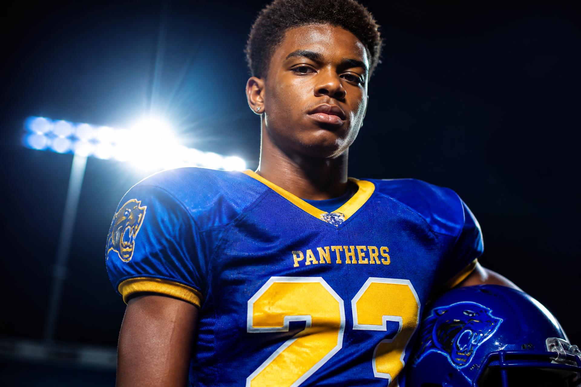 High school football player under stadium lights